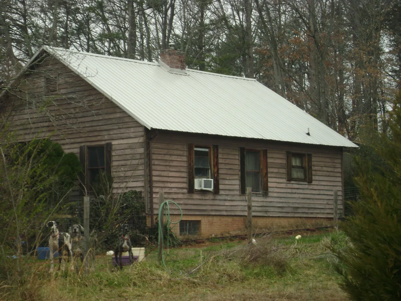 White metal roof on an old wood sided farmhouse, from a Asphalt Shingle Roof Repair job in Sioux City